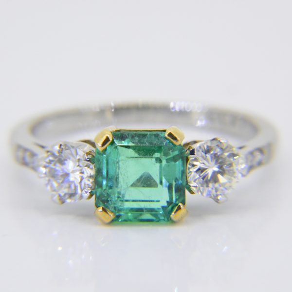 Emerald diamond three stone ring