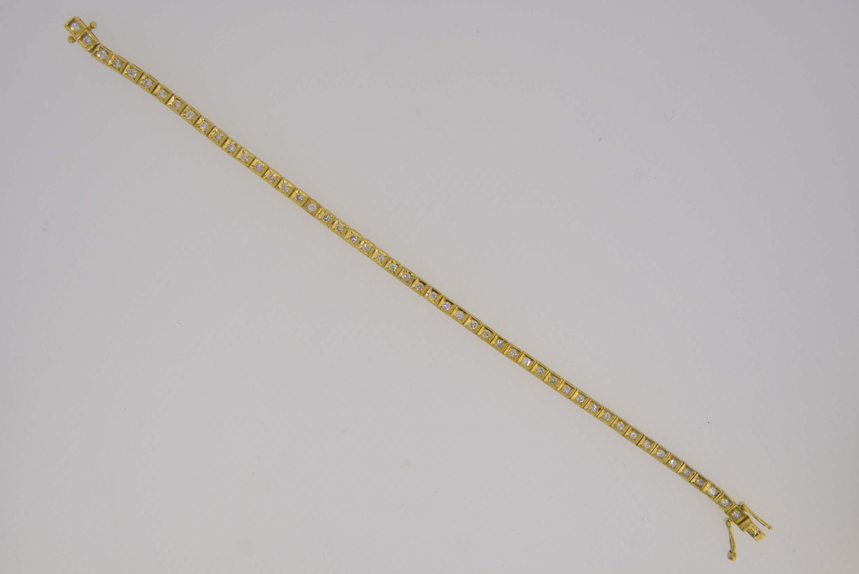 An 18ct yellow gold diamond line tennis bracelet - Jethro Marles