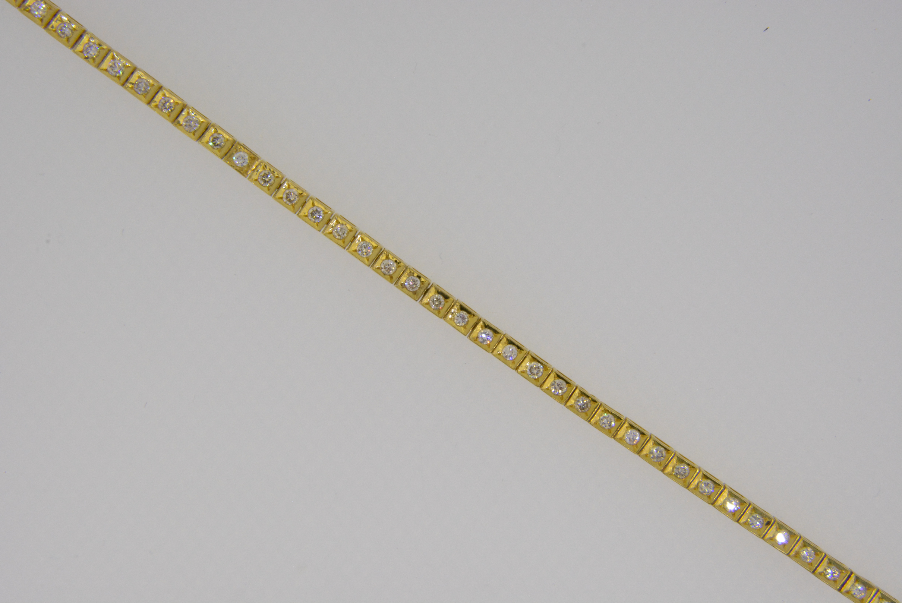An 18ct yellow gold diamond line tennis bracelet - Jethro Marles